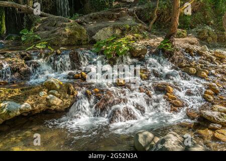 At the Volturno waterfalls the waters flow rapidly among the stones forming jumps and waterfalls.Castel San Vincenzo, Isernia, Molise Stock Photo