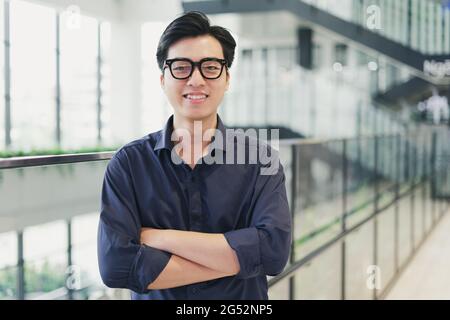 Portrait of an Asian business man, confident and smiling Stock Photo