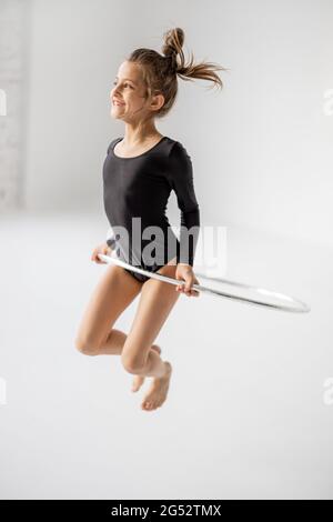 Girl practising rhythmic gymnastic with a ring Stock Photo