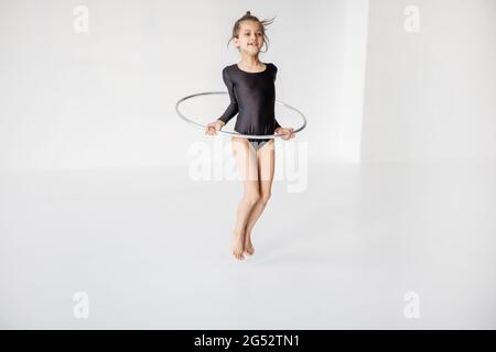 Girl practising rhythmic gymnastic with a ring Stock Photo