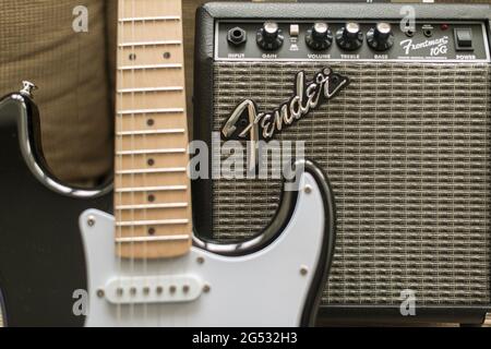 Fender Frontman 10 G,  beginers amplifier and Fender Stratocaster electric guitar, closep detail- selective focus Stock Photo