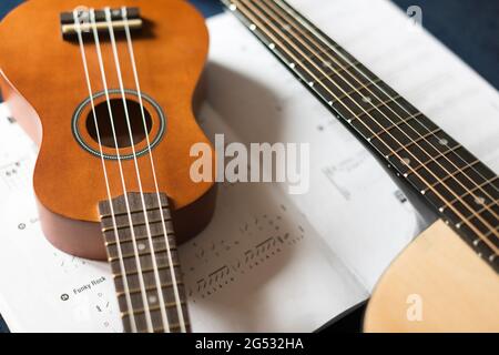 Ukulele , guitar and sheet music-close-up Stock Photo