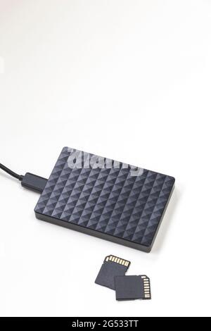 Storage device black external hard drive and sd Cards isolated on white background, Computer and Laptop storage concept Stock Photo