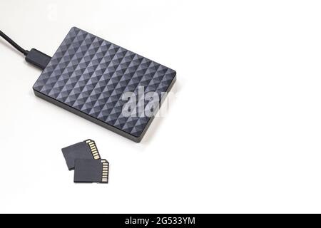 Storage device black external hard drive and sd Cards isolated on white background, Computer and Laptop storage concept Stock Photo