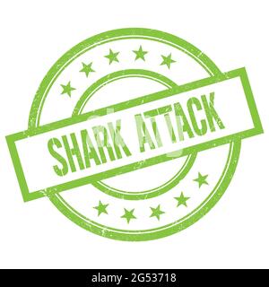 SHARK ATTACK text written on green round vintage rubber stamp. Stock Photo