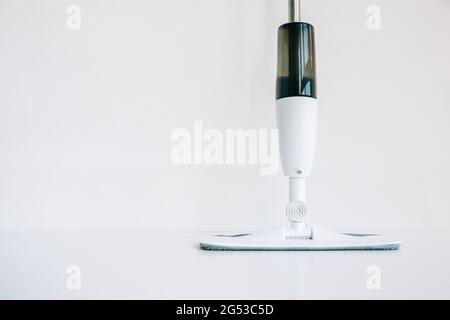 White mop with spray bottle isolated on white background with copy space... Stock Photo