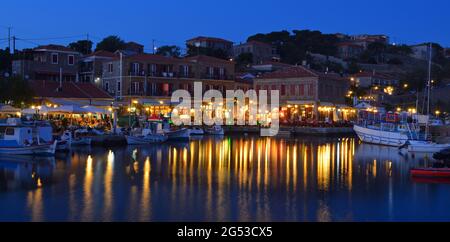 Holiday makers dining in harbor side restaurants Molyvos Greece Stock Photo