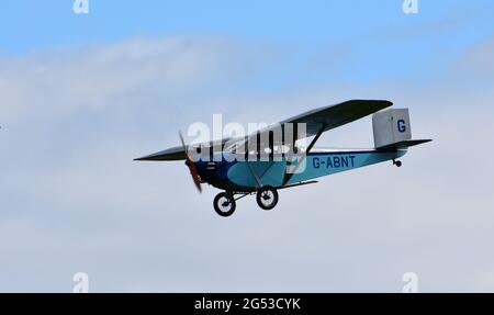 Vintage 1931 Civilian Coupe 02 G-ABNT  aircraft in flight  with blue sky and clouds. Stock Photo