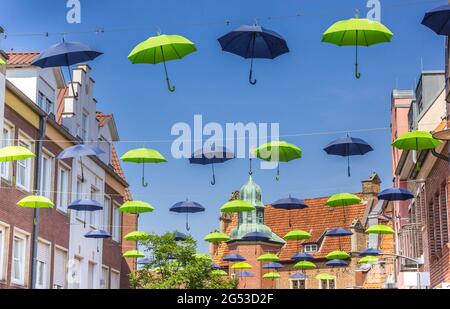 Many colorful umbrellas in front of the town hall of Meppen, Germany