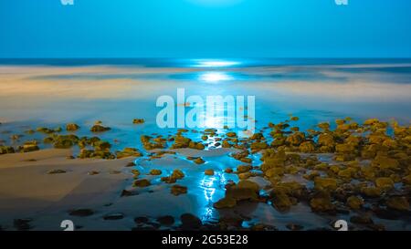 Beautiful seascape with a reflection of moon lights by night in Imesouane Morocco Stock Photo