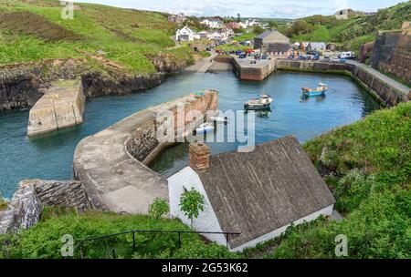 The sheltered harbour of Porthgain on the Pembrokeshire coast of South Wales UK once an busy port of the slate industry Stock Photo