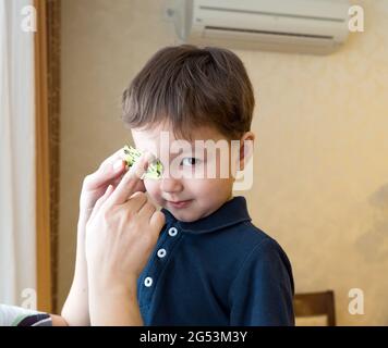 Little boy with okluder on the eye. Stock Photo