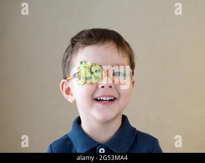 Little boy with okluder on the eye. Stock Photo