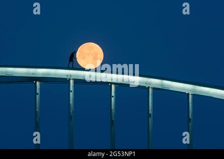 ZAGREB, June 25, 2021 A man poses on top of a railway bridge above the Sava River during full moon in Zagreb, Croatia, June 24, 2021. (Bruno Fantulin/Pixsell via Xinhua) Credit: Xinhua/Alamy Live News Stock Photo