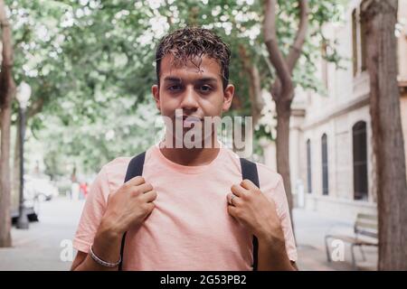 Portrait young latin man student with bag. Latino guy at the university campus Stock Photo