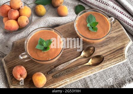 Apricot smoothie with yogurt and mint petals. Stock Photo