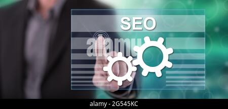 Man touching seo concept on a touch screen with his finger Stock Photo