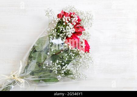 Colorful flowers bunch of red roses with alstroemeria and white gypsophila Stock Photo