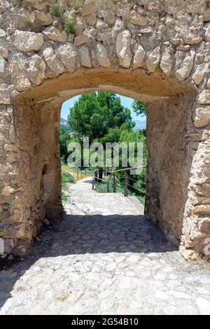 Opening of the exit from the stone wall of the medieval castle in the direction of the stairs leading down. Stock Photo