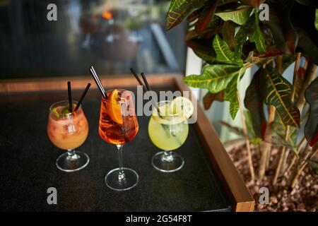 Three summertime cocktails in a bar Stock Photo