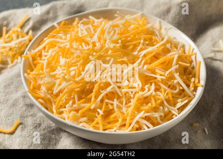 Organic Shredded Mexican Cheese Mix in a Bowl Stock Photo