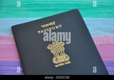Mandi, Himachal Pradesh, India - 04 24 2021: Closeup shot of Indian passport over multi colored medical face mask (surgical mask), Concept of traveling during Covid19 pandemic Stock Photo