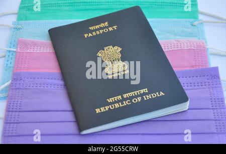 Mandi, Himachal Pradesh, India - 04 24 2021: Closeup shot of Indian passport over multi colored medical face mask (surgical mask), Concept of traveling during Covid19 pandemic Stock Photo