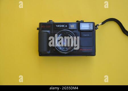 Mandi, Himachal Pradesh, India - 04 24 2021: High angle view of a Yashica film roll camera MD-35f isolated over yellow background Stock Photo