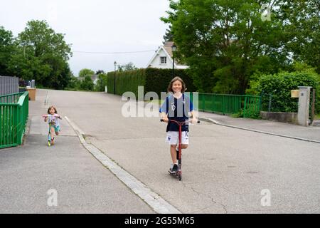 Young boy on a red scooter. Stock Photo