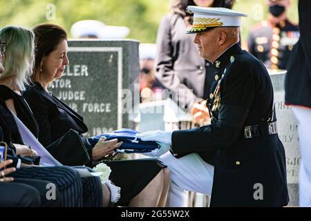 U.S. Marine Corps Commandant Gen. David Berger presents the flag to Jeanne Warner, wife of former U.S. Senator and Marine Corps 1st Lt. John Warner during his funeral in Arlington National Cemetery June 23, 2021 in Arlington, Virginia. Warner, a Senator for Virginia for 30-years and Secretary of the Navy died May 25th. Stock Photo