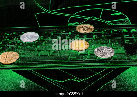 Cryptocurrencies on a black abstract background on which there is a keyboard and green colored graphs and binary numbers that are subtly visible. The Stock Photo