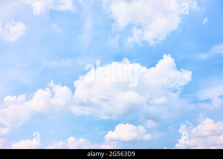 Sky with white heap clouds , may be used as background. Cloudscape Stock Photo