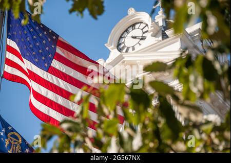American flag and Georgia state flag at the Gwinnett Historic Courthouse on the town square in Lawrenceville, Georgia. (USA) Stock Photo