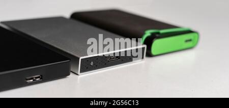 three external hdd drives one the shelf, data backup storage Stock Photo