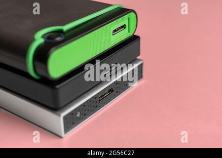 three external hdd drives one the shelf, data backup storage Stock Photo