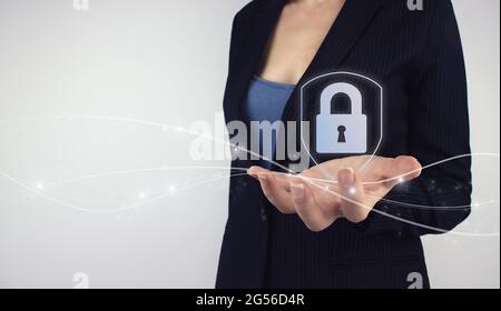 Data protection, cyber security concept. Hand hold digital hologram icon security padlock with data protection on grey background. Protection business Stock Photo