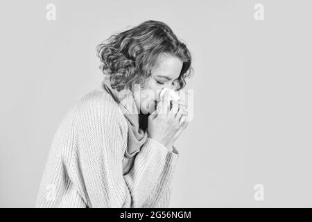 sneezing in napkin. Symptoms of disease. runny nose caused by illness. ill with laryngitis. Acute respiratory viral. sick woman runny nose. influenza Stock Photo