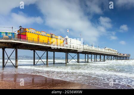 Paignton Pier on a blustery spring day in south Devon. The 780 feet pier, with its customary grand pavilion at the seaward end, first opened in 1879. Stock Photo