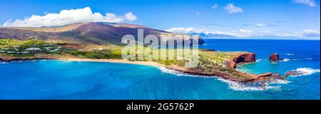 Aerial panoramic view of Lanai, Hawaii featuring Hulopo'e Bay and beach, Sweetheart Rock (Pu'u Pehe), Shark's Bay, and the mountains of Maui Stock Photo