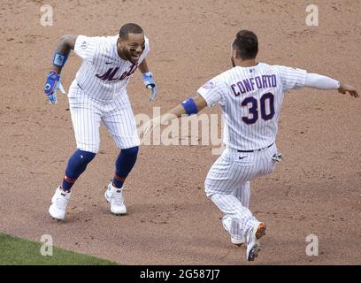 Queens, USA. 25th June, 2021. New York Mets Michael Conforto celebrates with Dominic Smith who hits a walk off game winning RBI single in the bottom of the 8th inning in game one of a double header against the Philadelphia Phillies at Citi Field on Friday, June 25, 2021 in New York City. The Mets defeated the Phillies 2-1 in extra innings. Photo by John Angelillo/UPI Credit: UPI/Alamy Live News Stock Photo
