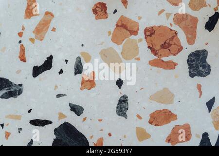 White marble bench texture with pastel blue and orange speckled pattern. Stock Photo