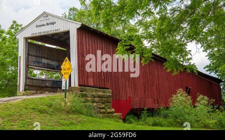 The Crooks Covered Bridge is a single span Burr Arch Truss structure that crosses Little Raccoon Creek built in 1855-1856 by Henry Wolf just southeast Stock Photo