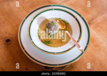 Leberknoedelsuppe, an Austrian Liver Dumpling Soup, a Beef Broth with Chives with Spoon Stock Photo