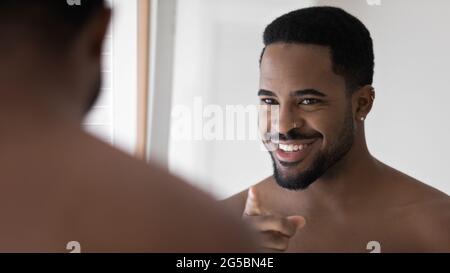 Happy handsome Black metrosexual guy with facial piercing Stock Photo