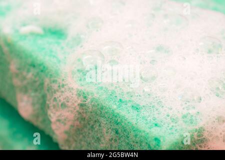 Soap suds on a green sponge Stock Photo
