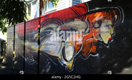 Colorful graffiti mural showing a space girl travelling through time on a suburban wall in Brisbane Australia Stock Photo