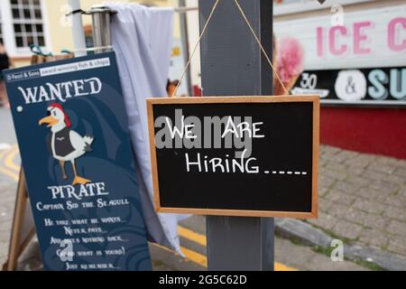 staff wanted, vacancies, we are hiring, we are recruiting, jobs available...job vacancy signs in Welsh holiday resort Tenby, Pembrokeshire Stock Photo