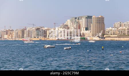 Modern houses and boats at waterfront of Sliema, Malta Stock Photo