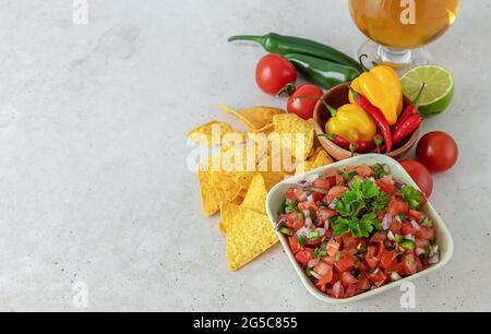 Pico de gallo or salsa fresca, made from tomato, onion, serrano pepper, lime juice, cilantro, and salt.  Stock Photo