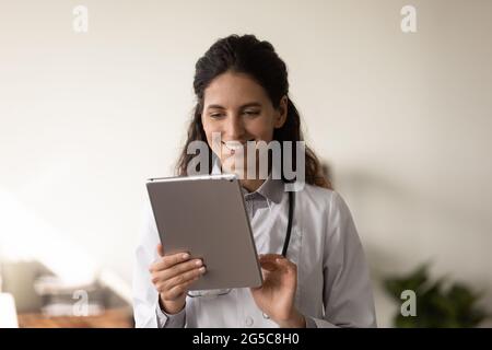 Smiling female doctor use modern tablet in hospital Stock Photo